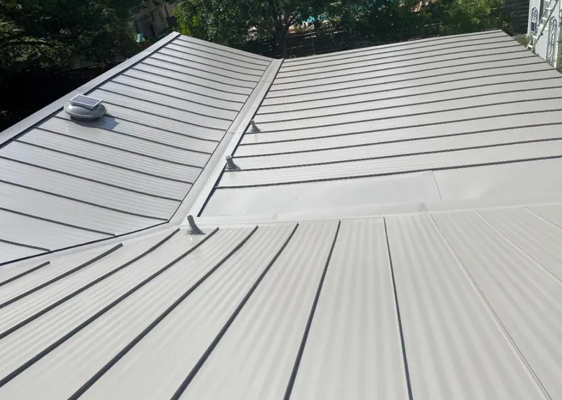 Solar attic fan installed on a metal roof for Roof Ventilation in Rome